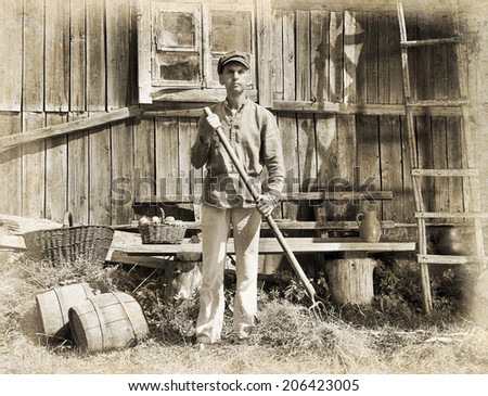 Male farmer holding a pitchfork. Intentional 1900\'s style post processing emulation.