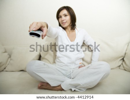 Young woman hold remote control in her hand