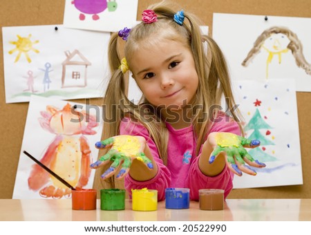 Little girl shows her painted hands