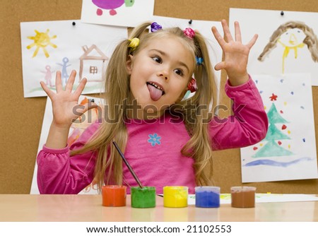 Little girl makes a grimace at drawing lesson