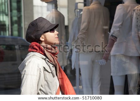 Young woman Looking Inside A Shop\'s Window