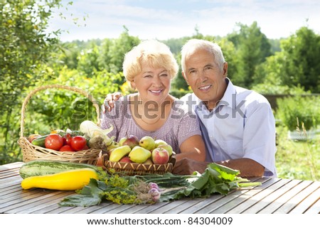 Portrait of elderly couple with fresh vegetables on the table