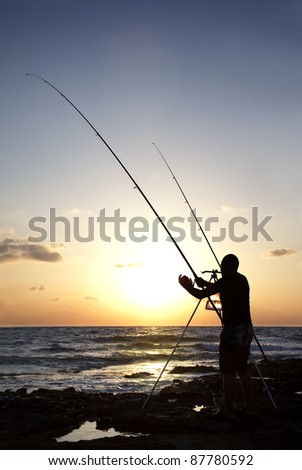 Fisherman silhouette fishing during sunset. Mediterranean Sea, Cyprus