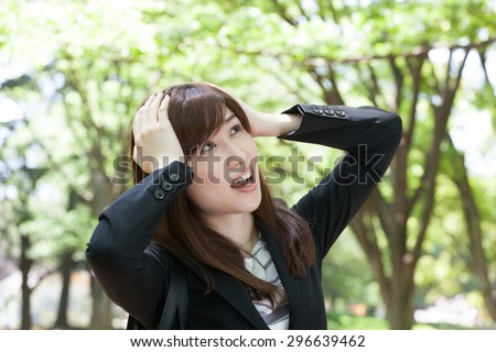 business woman hold head shocking