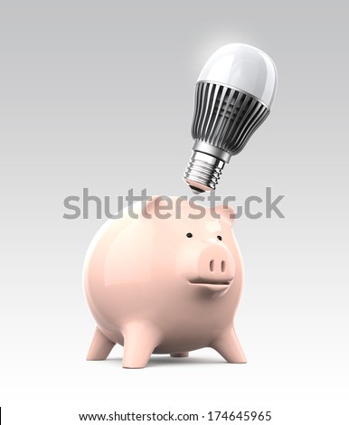 Piggy bank and LED light bulb. Concept for energy saving LED light saving money