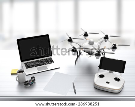 Hexacopter, remote controller, laptop on desk with office interior background