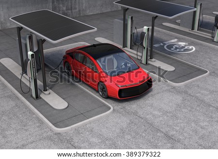 Electric vehicle charging station in public space. The charging spot support by solar panels, storage batteries.