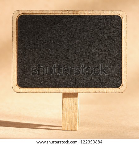 blank standing blackboard on brown background