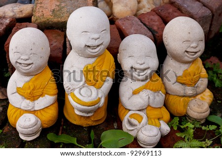 stock-photo-group-of-smiling-little-buddhist-monk-statues-92969113.jpg