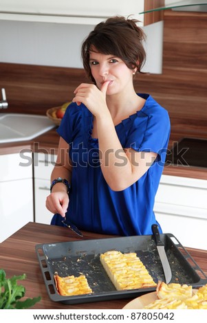 Beautiful brunette woman Bake cake in the kitchen