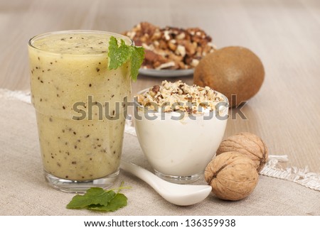 Fitness breakfast with yogurt, smoothies out of kiwi fruit and walnuts.