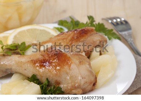 Fried chicken legs with canned pineapple.