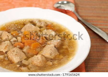 Soup with meat, mushrooms and carrots.
