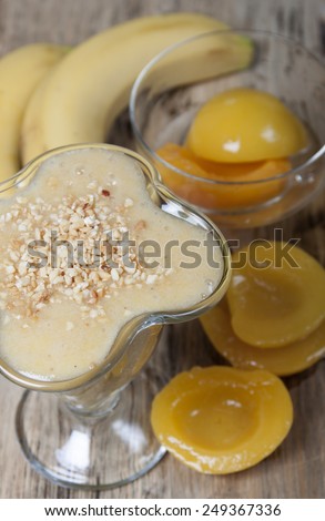 Smoothie of banana and canned peaches with nuts.