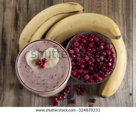 Smoothie of banana and frozen cranberries with yogurt on an old table.Top view.