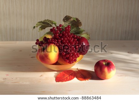 Apples and cranberry high berries in a plate on desktop.