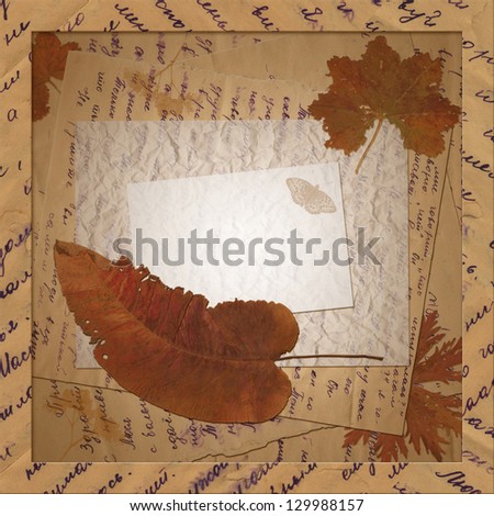 Vintage postcard with old letters and dried leaves