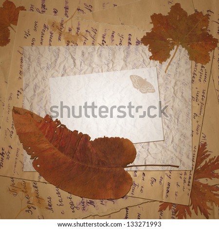 Vintage postcard with old letters and dried leaves