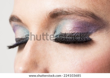 Eyes with makeup on purple and green