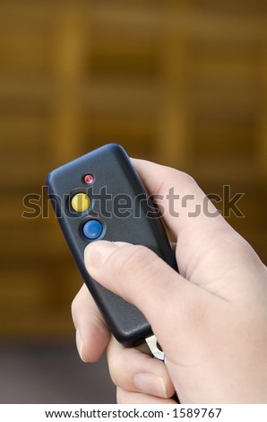 Holding remote control to open garage door