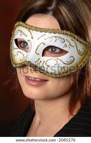 Brunette model with a masquerade mask on her face