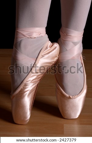 Ballerina with ballet shoes standing with pointed toes