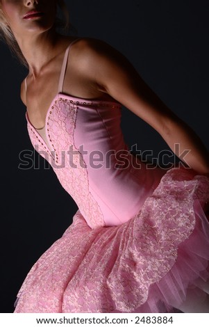 Ballerina with pink tutu standing in a ballet pose (no eyes showing)