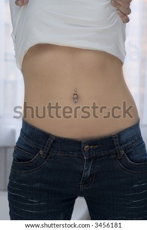 stock photo Woman undressing her white shirt so that you can see her navel