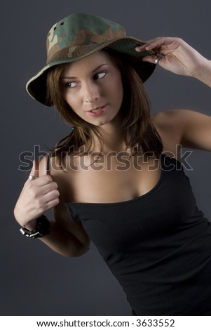 Attractive brunette military girl with a camouflage hat and black shirt