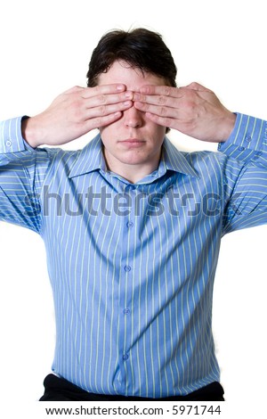 Business man with blue shirt holding both hands in front of his eyes to prevent him from seeing