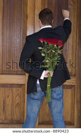 Man knocking on door to present flowers to his date on valentines day