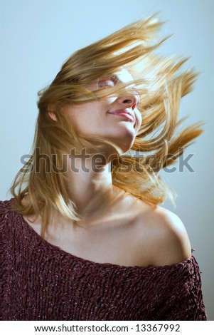 Girl throwing hair to the left where light is coming from