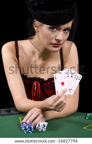 Poker playing showing the dealer her hand of four aces in a poker game