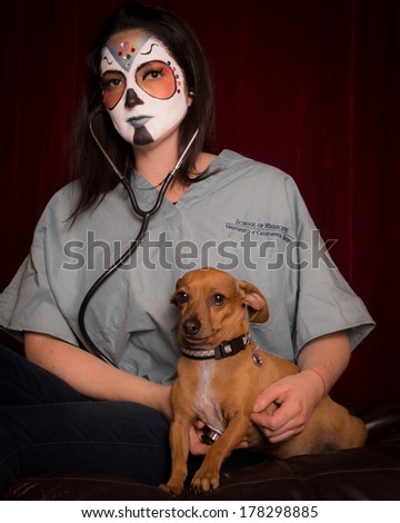 Day of The Dead veterinarian with stethoscope caring for dog
