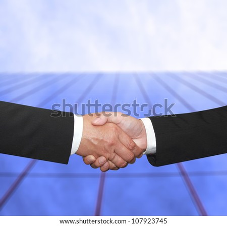 shake hand in front of a building for agreement