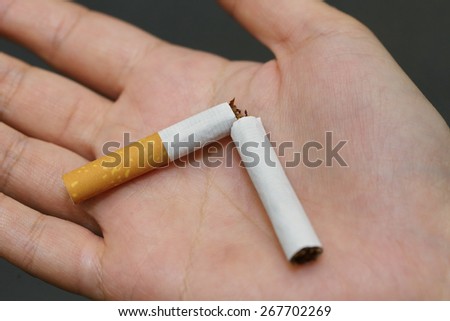 broken cigarette on the palm after quite smoke