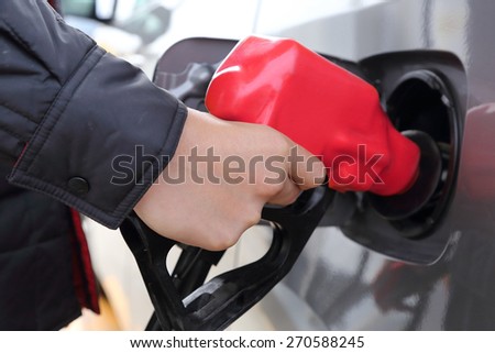 background of hand filling the car fuel of the car