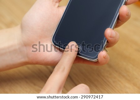 female using her fingerprint to scan the phone