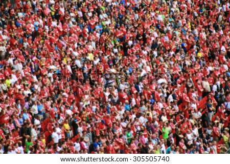 blurred crowd of spectators in a stadium in a football match