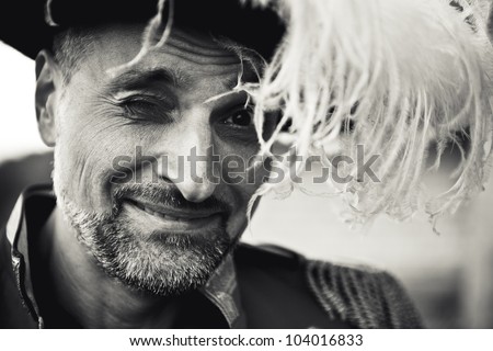 happy elderly man in a hat smiles