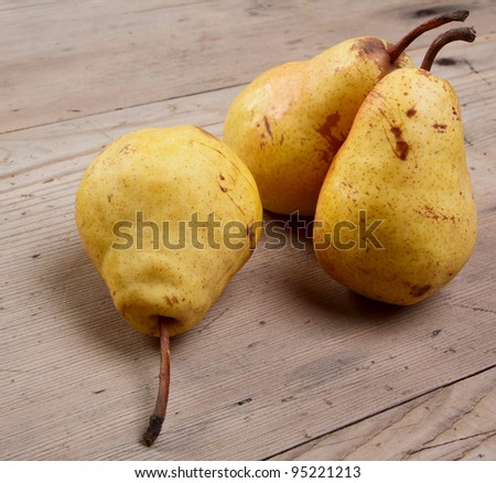 Three pears on an old wooden table