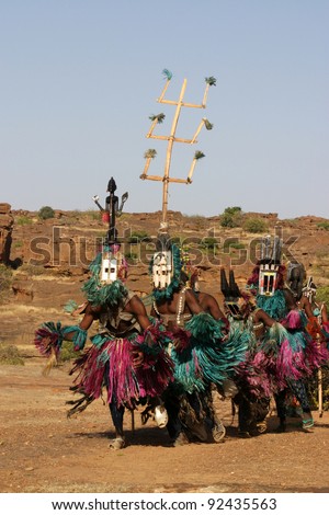 Several Dogon dancers with masks performing a ritual dance. Masks which may symbolize animals are sometimes traveling through several villages. Some masks are only used in a 60 year cycle.
