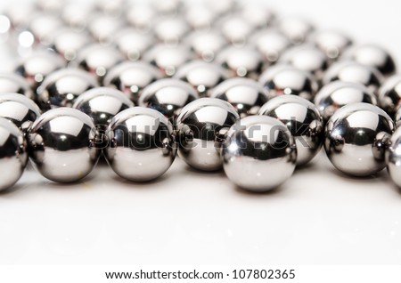 Metallic bearing balls on white background