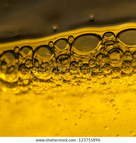 An abstract shot of bubbles forming in some liquid detergent.