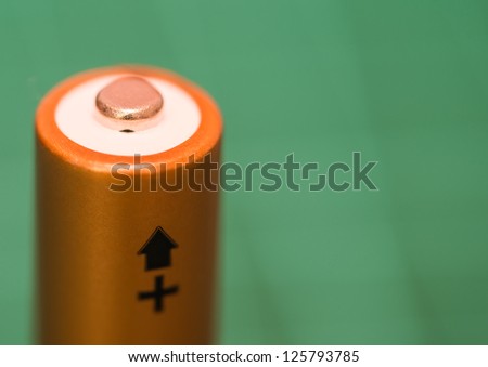 A macro shot of the positive terminal of a single battery.