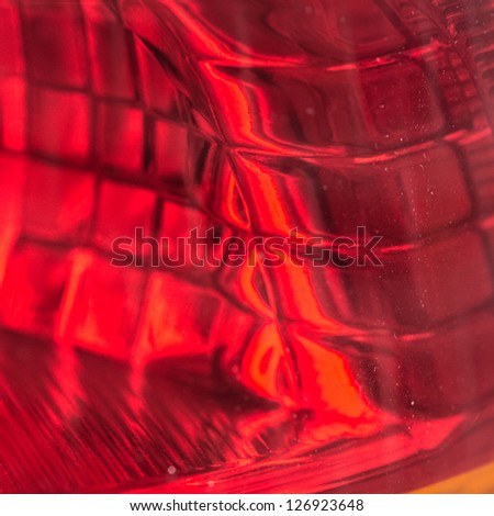 A abstract close-up of the brake light fitting from the rear of a car.