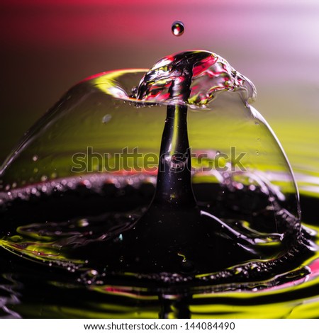An abstract macro shot of water drops colliding within a soap bubble.
