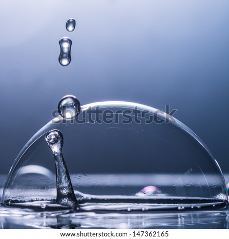 A macro shot of a water spike with a water droplet.