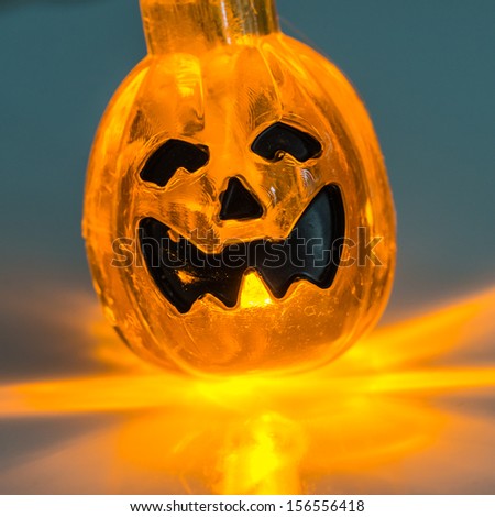 A macro shot of a pumpkin lamp.
