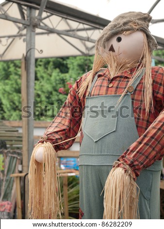 A straw man welcomes people to the garden centre.
